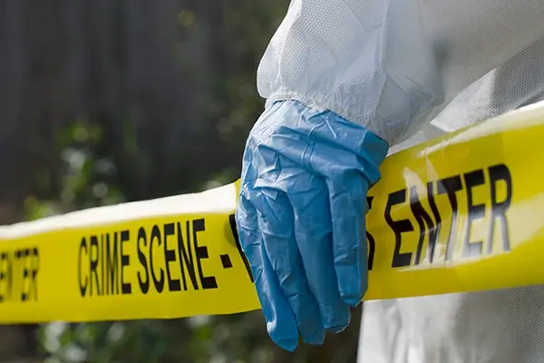 Biohazard cleanup technician at a secured trauma scene